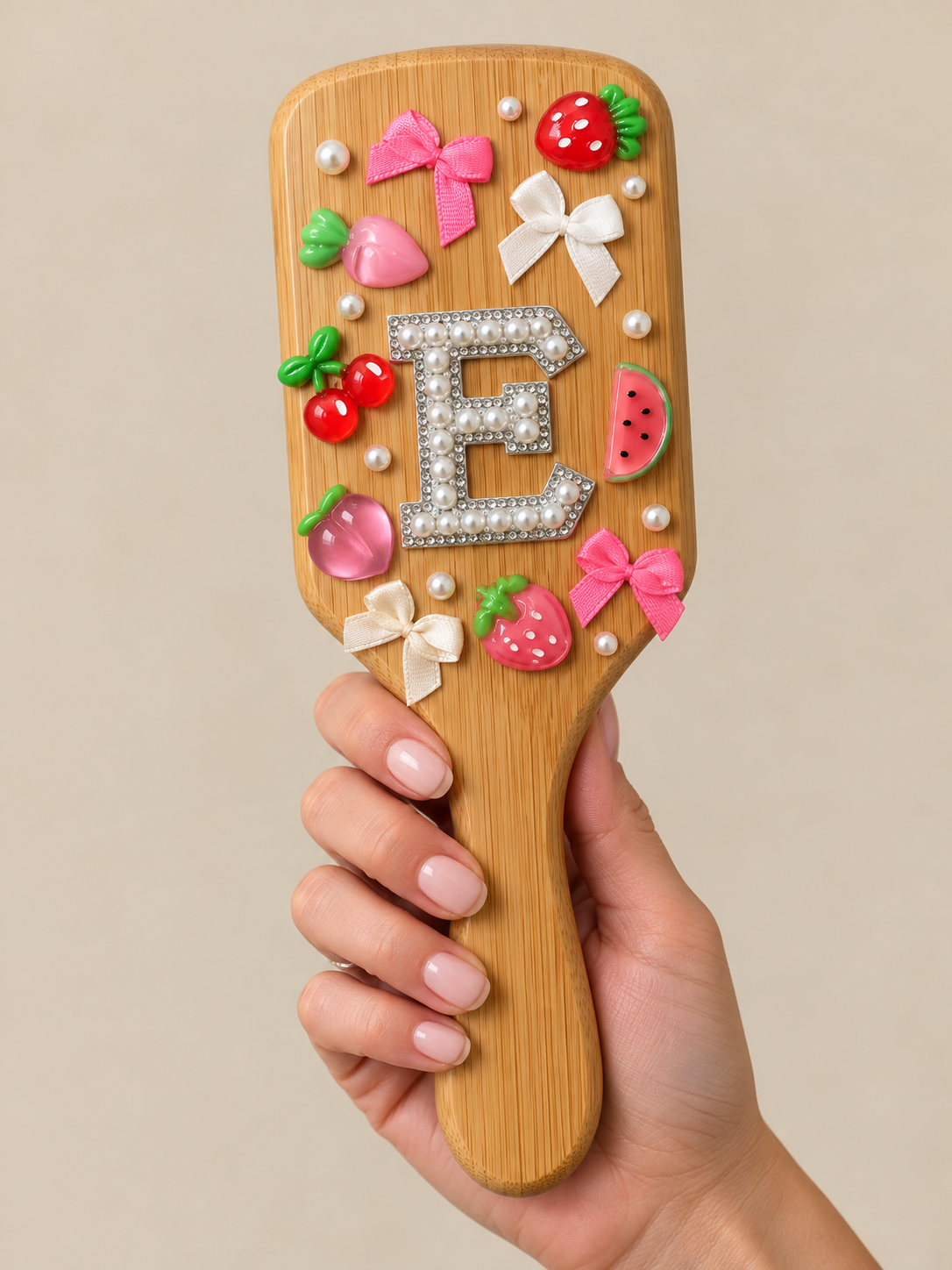 Decorative hairbrush with colorful strawberry, cherry, watermelon, bows, and pearl embellishments.
