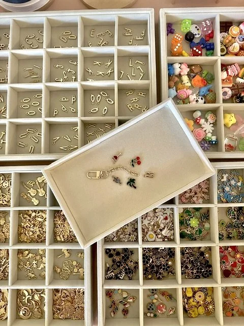 Close up photo of colorful charms and a keychain base.