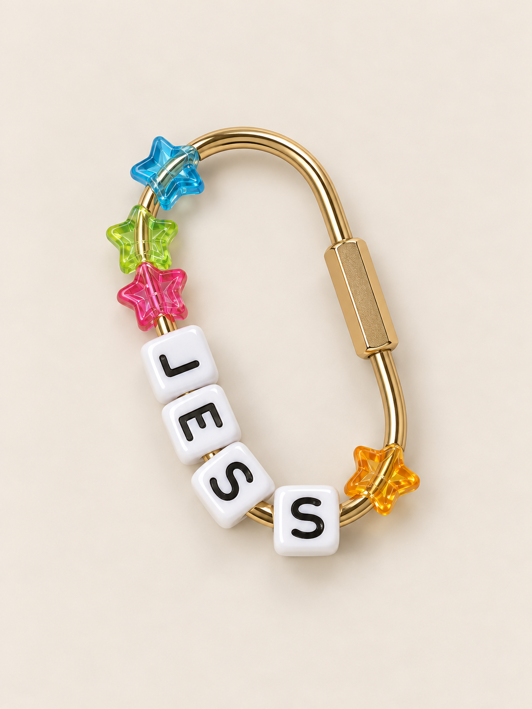 Golden bracelet with colorful star-shaped beads and white letter beads spelling 'LOST' on a beige background.