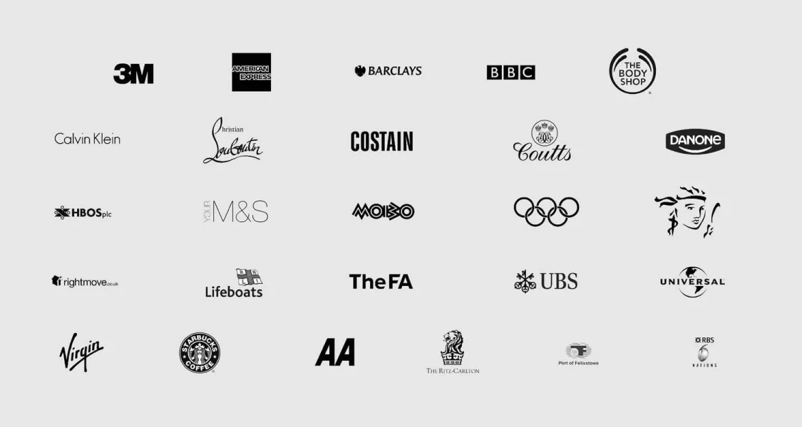 Collection of various company logos on a gray background, including 3M, American Express, Barclays, BBC, Body Shop, Calvin Klein, Christian Louboutin, Costain, Coutts, Danone, HBO, M&S, Mobo, Olympics, HBO, Lifeboats, The FA, UBS, Universal, Virgin, Starbucks, The Ritz-Carlton, Port of Felixstowe, RBS, and Publishers.