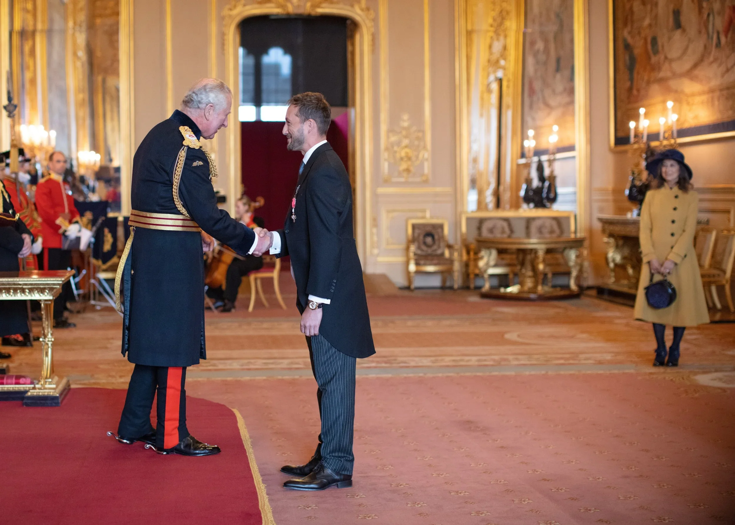 Joe Blackman shaking hands with King Charles