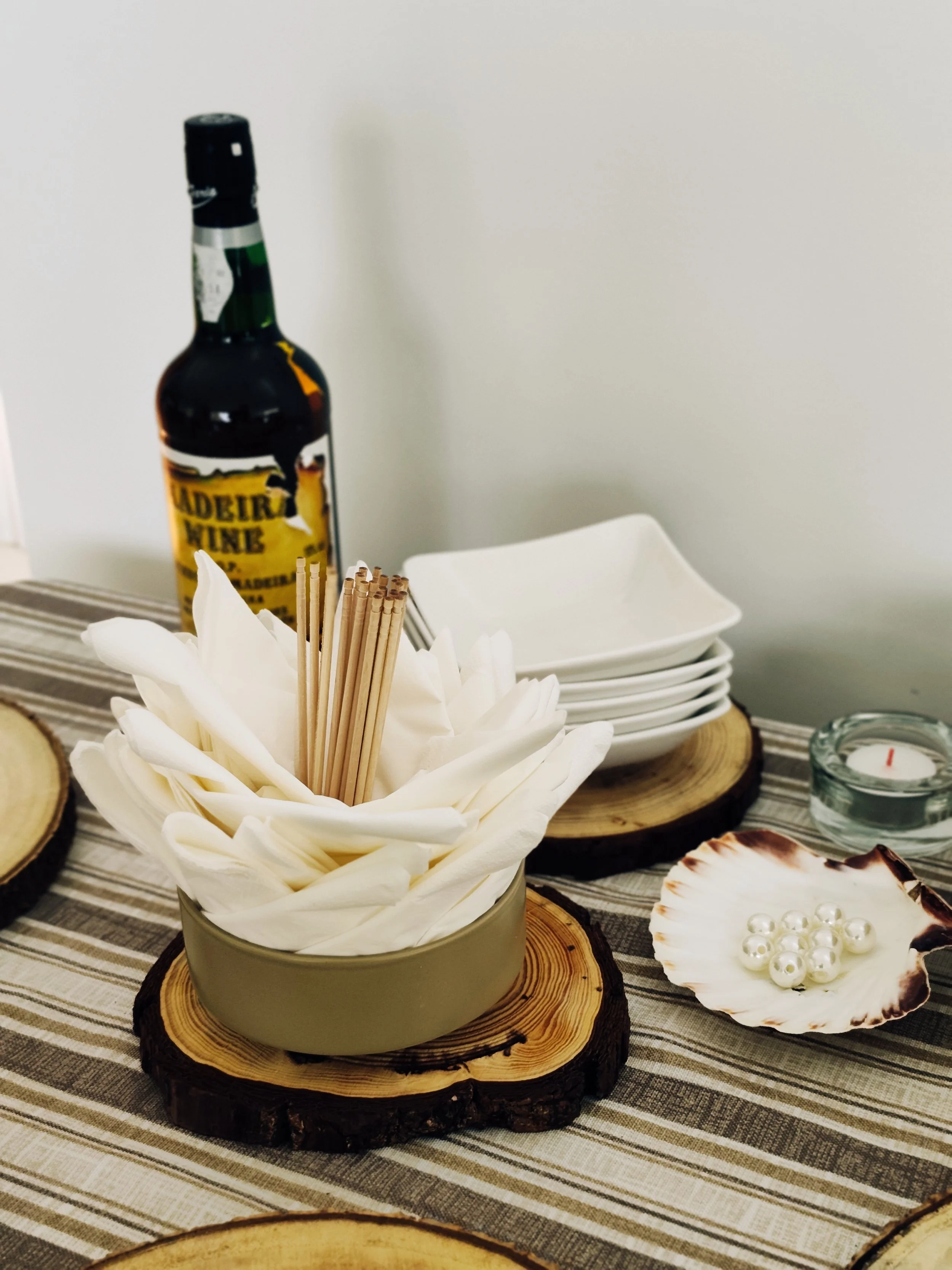 Table service arrangement with Madeira wine, folded napkins and plates