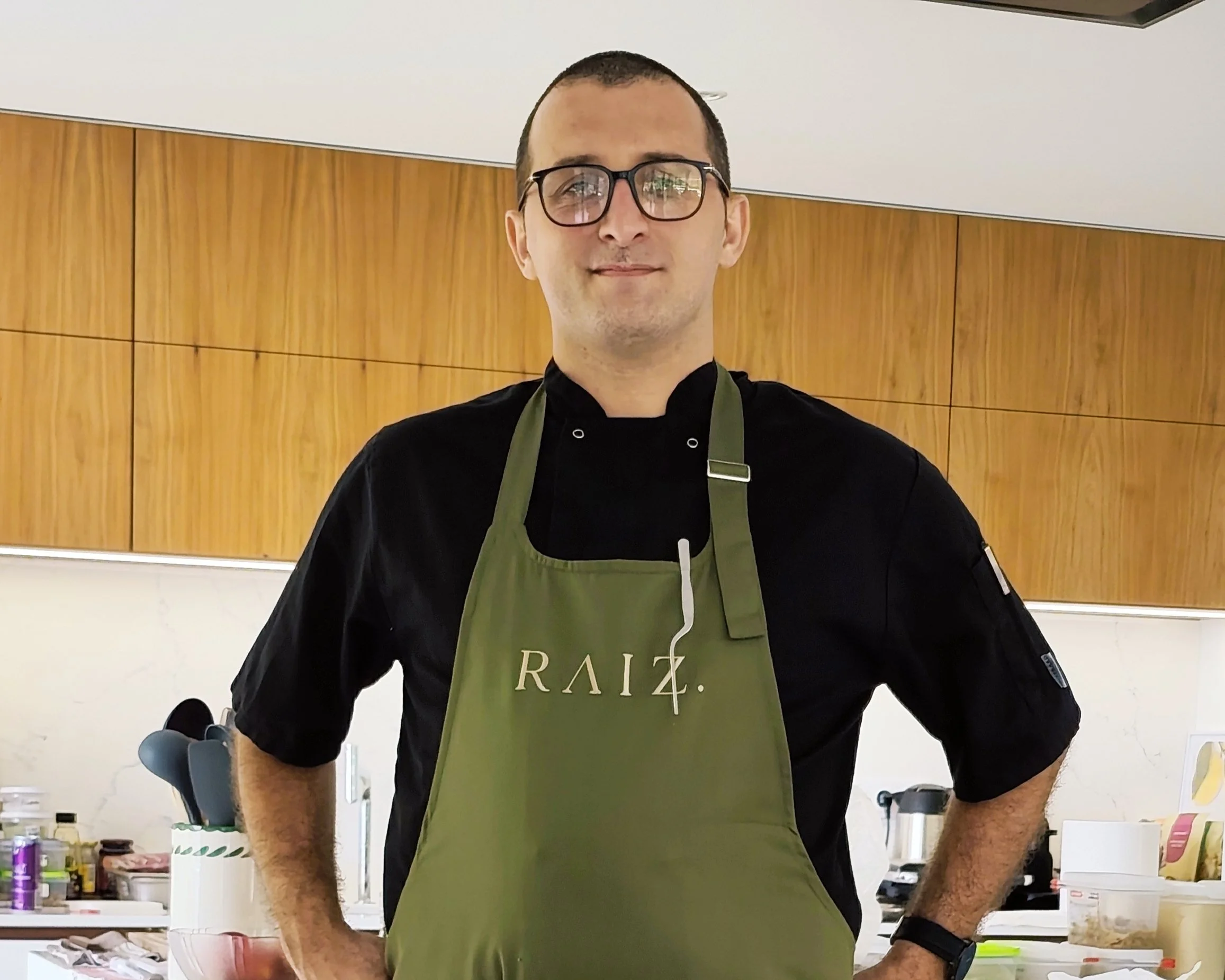 Man wearing a RAIZ. apron in a kitchen