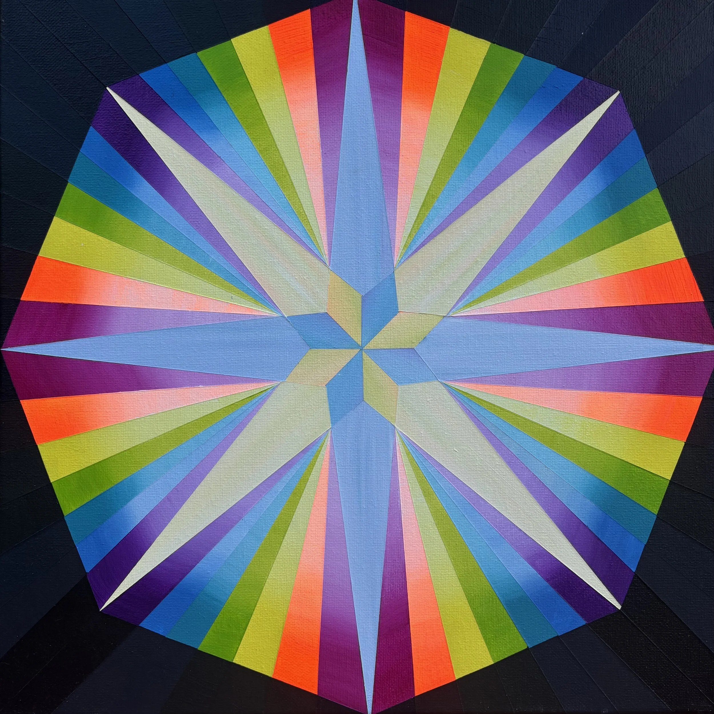 Close-up of a colorful geometric pattern resembling an abstract sun or radiating design with vibrant rainbow-colored segments on a dark background.