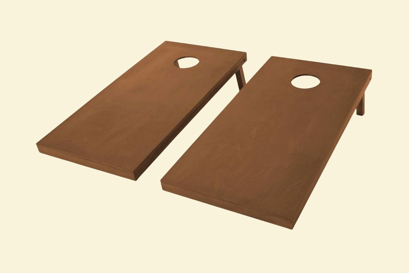 Two wooden cornhole game boards with circular holes in the center, set against a plain background.