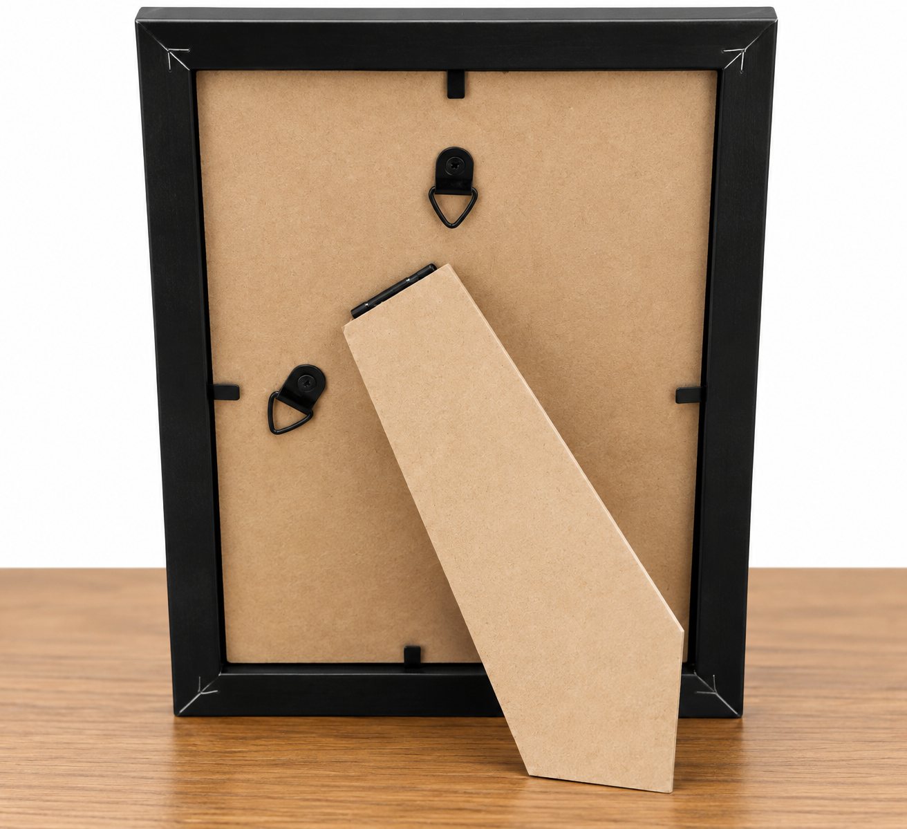 Back of the Golden Hour 5x7 black frame showing the tan backing, built-in easel stand, frame fasteners, and hanging hardware.