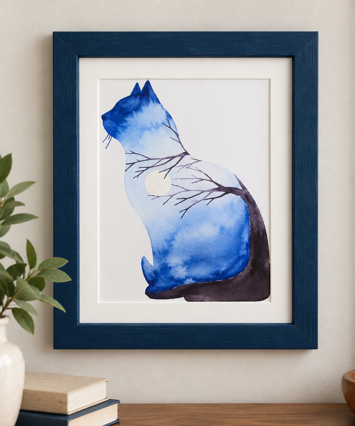 Blue Whiskers framed cat watercolor print displayed on a neutral wall, featuring a blue cat silhouette with dark branches and a pale moon in an 8x10 blue frame.