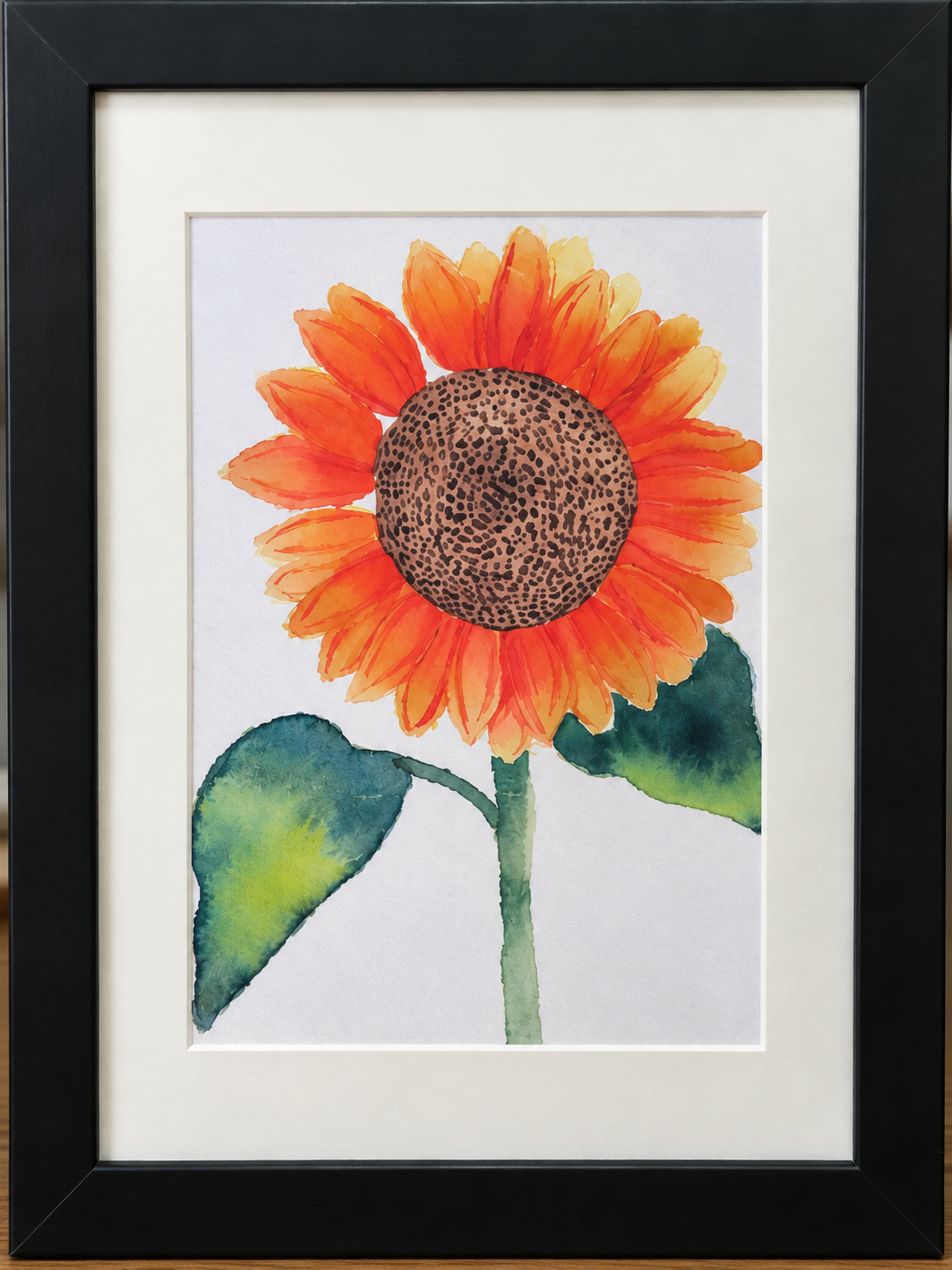 Close-up of Golden Hour framed watercolor print featuring an orange and golden sunflower with green leaves.