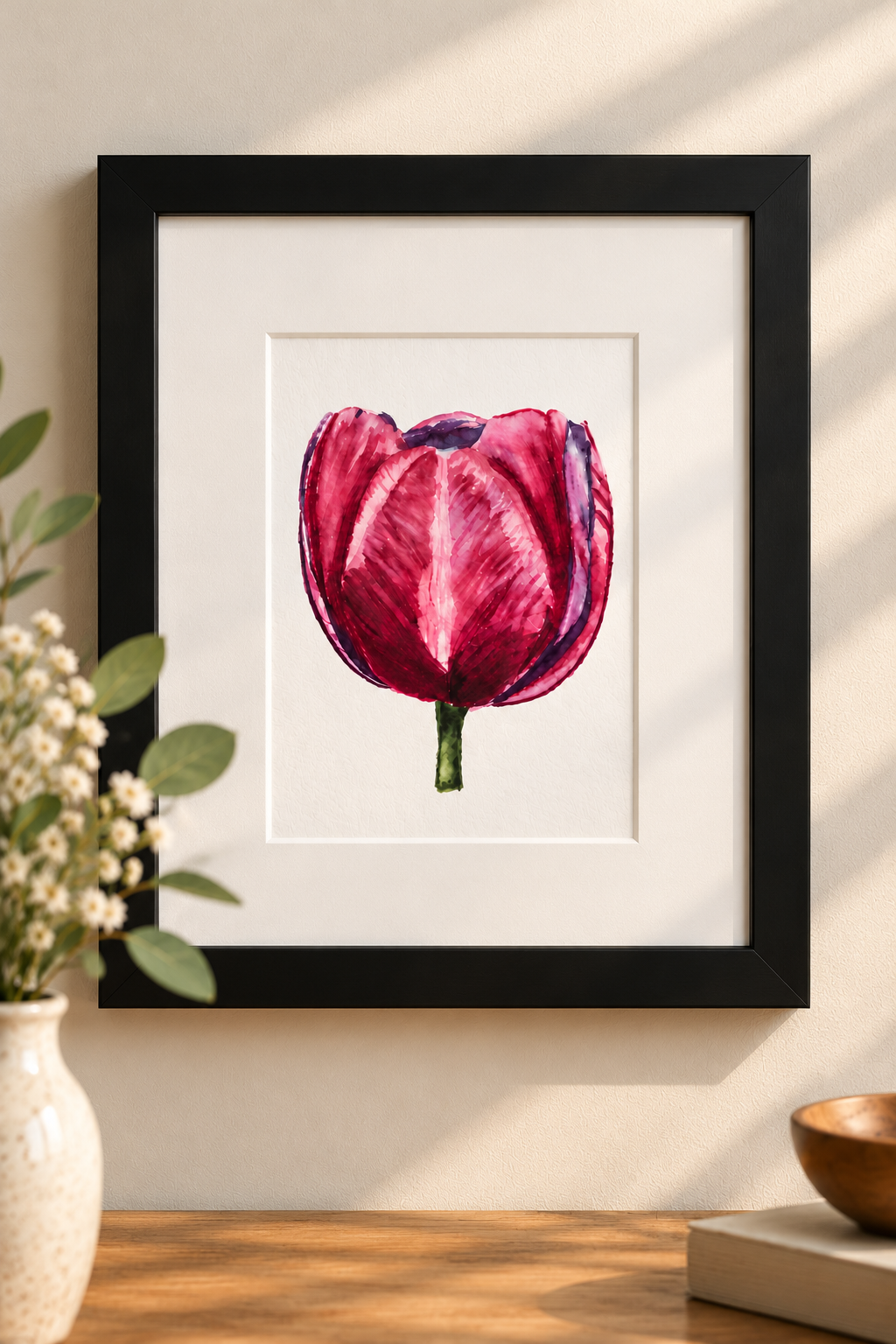 Pink and burgundy watercolor tulip 5×7 print with white 8×10 mat displayed in a solid black frame on a warm neutral wall.