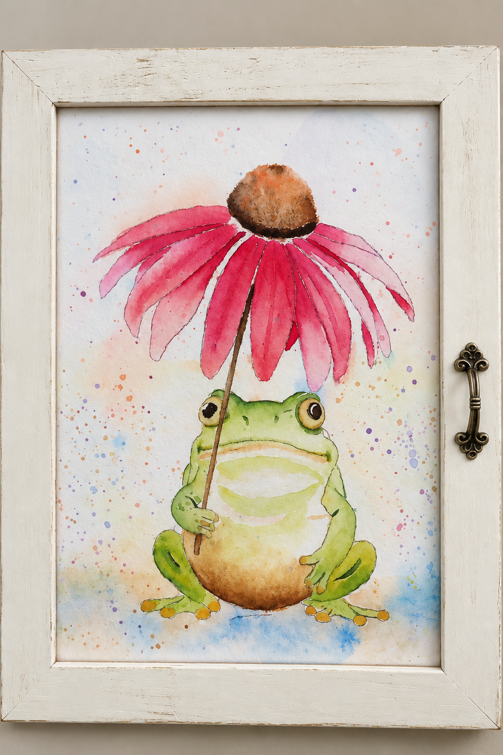 Close-up of the framed Under the Coneflower watercolor print showing a whimsical green frog beneath a bright pink coneflower with colorful watercolor splatters.