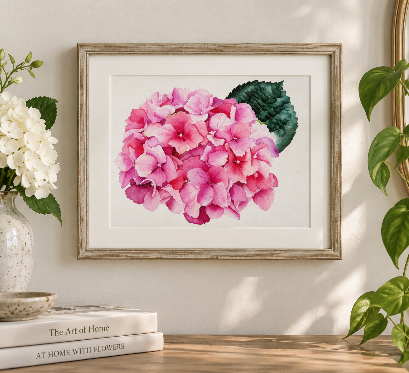 Pink watercolor hydrangea print displayed in a frame, featuring soft blush and vibrant pink blossoms with rich green leaves.