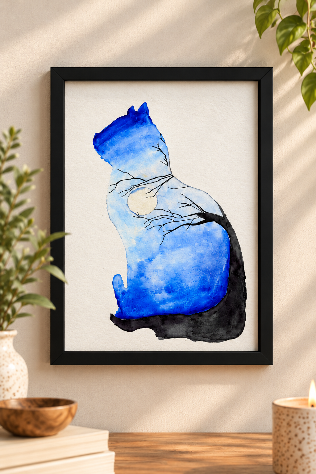 Alt text: Blue watercolor cat print with moon and tree branch details displayed in a black 8x10 frame on a warm neutral wall.