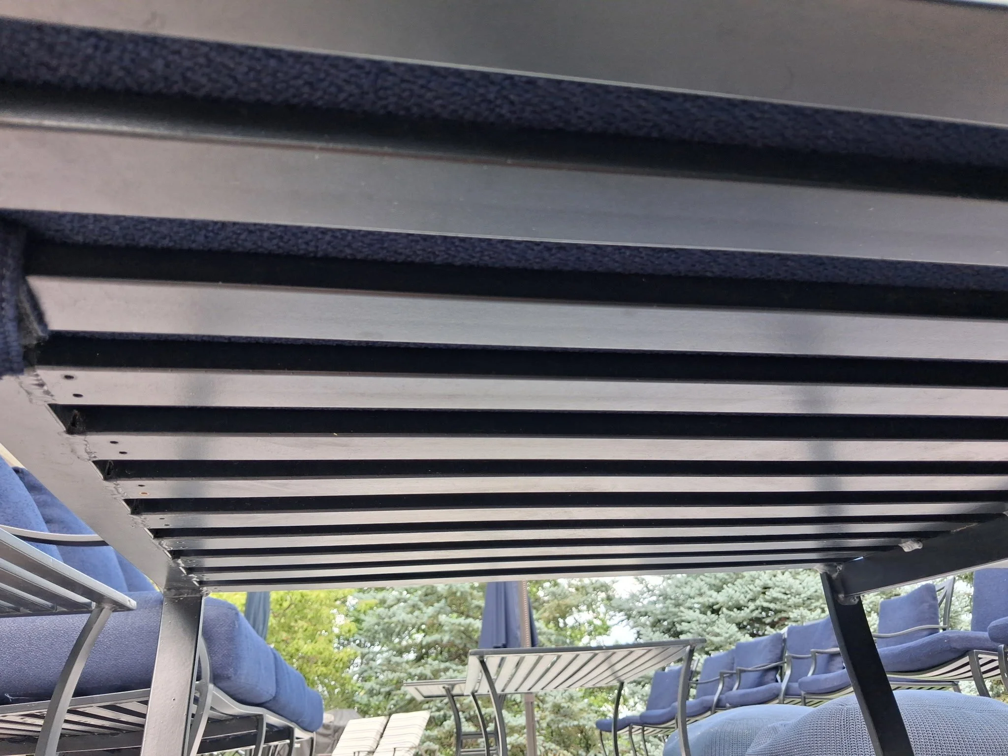 Outdoor patio furniture and living area detailed by RWC as part of residential exterior property care.