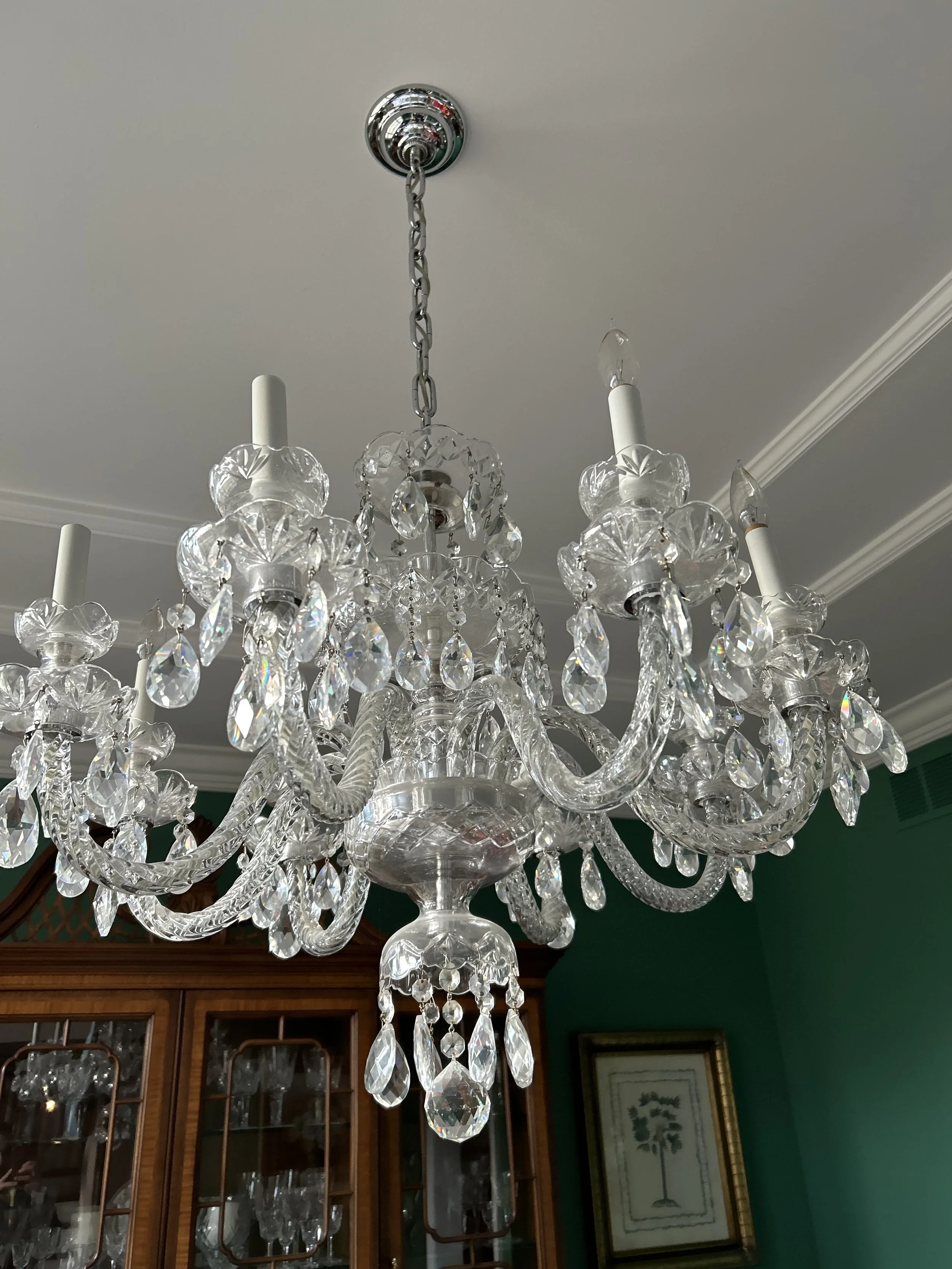 Crystal chandelier professionally cleaned and detailed by RWC, including individual crystals, arms, and fixture surfaces.