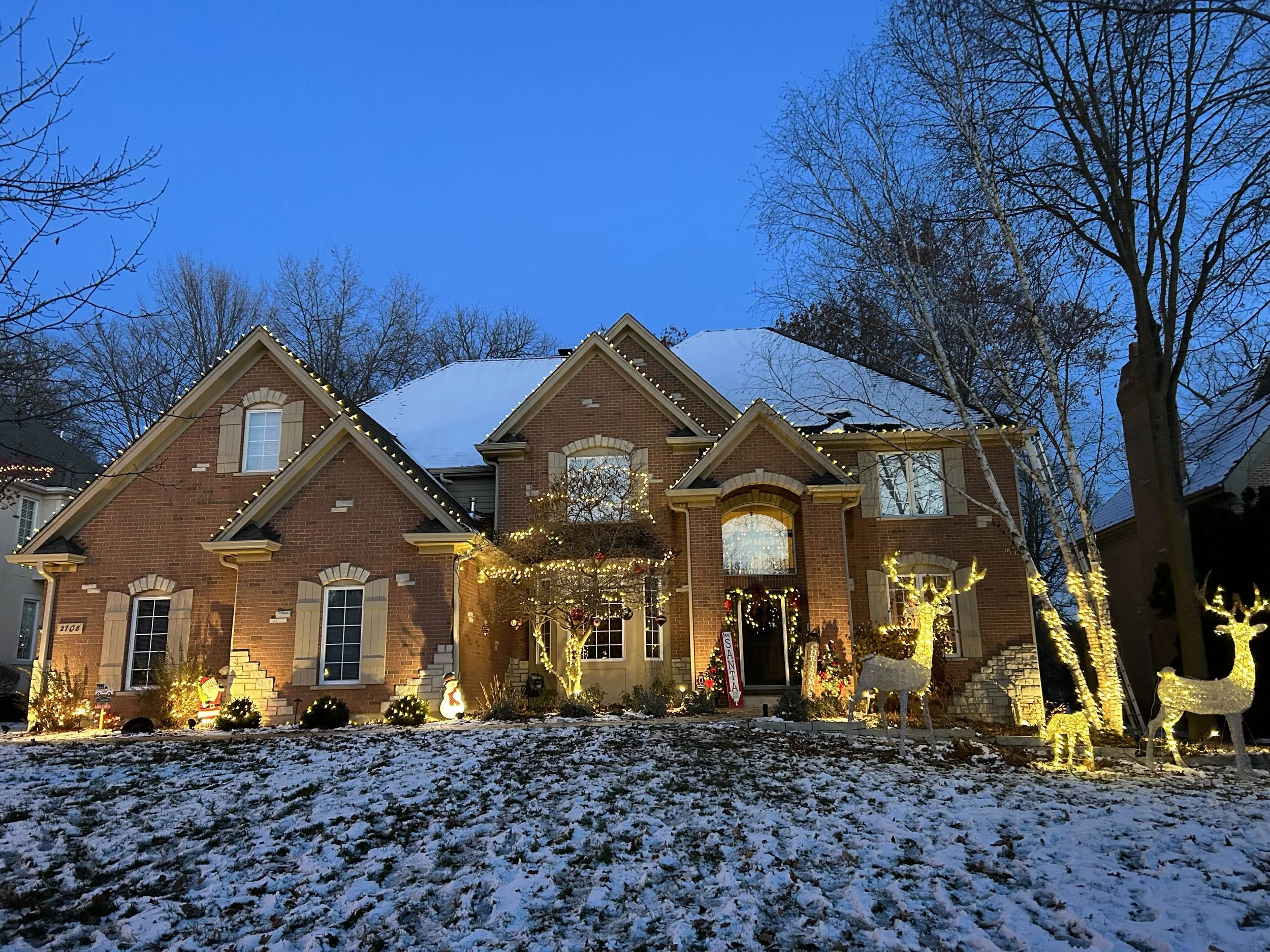 Residential holiday lighting installation by RWC featuring professional roofline and exterior Christmas lights on a home at dusk.