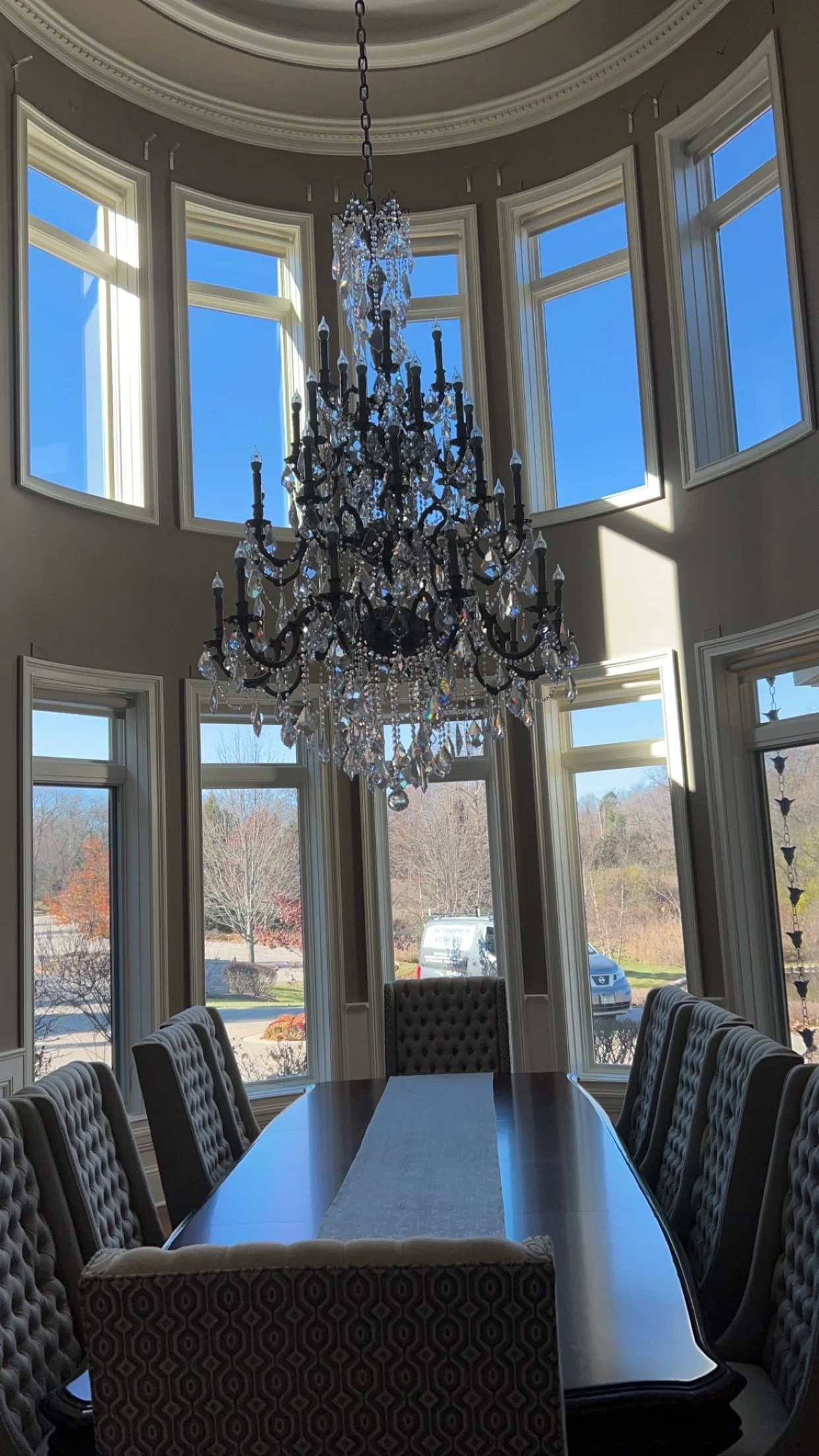Residential chandelier and windows professionally cleaned by Reflect Window Cleaning (RWC) as part of detailed interior property care.