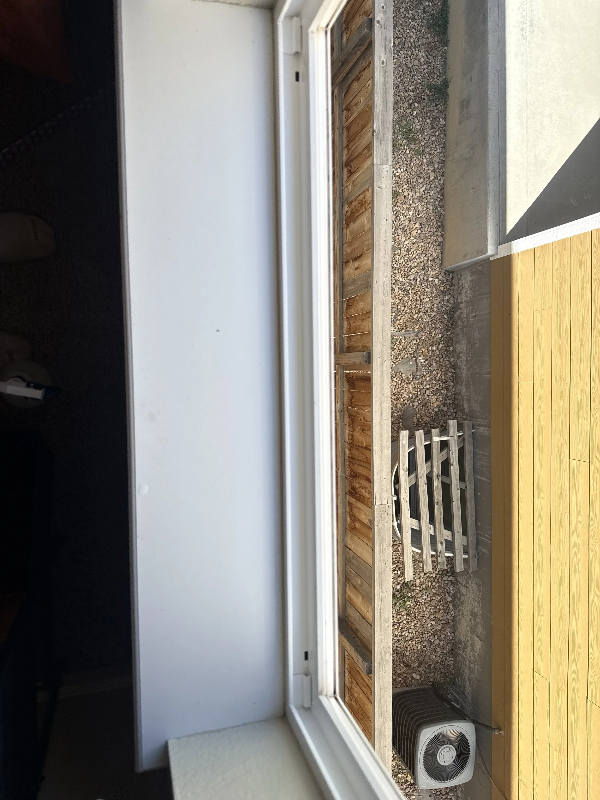 Residential exterior property care by RWC featuring detailed cleaning and maintenance around window track/sill