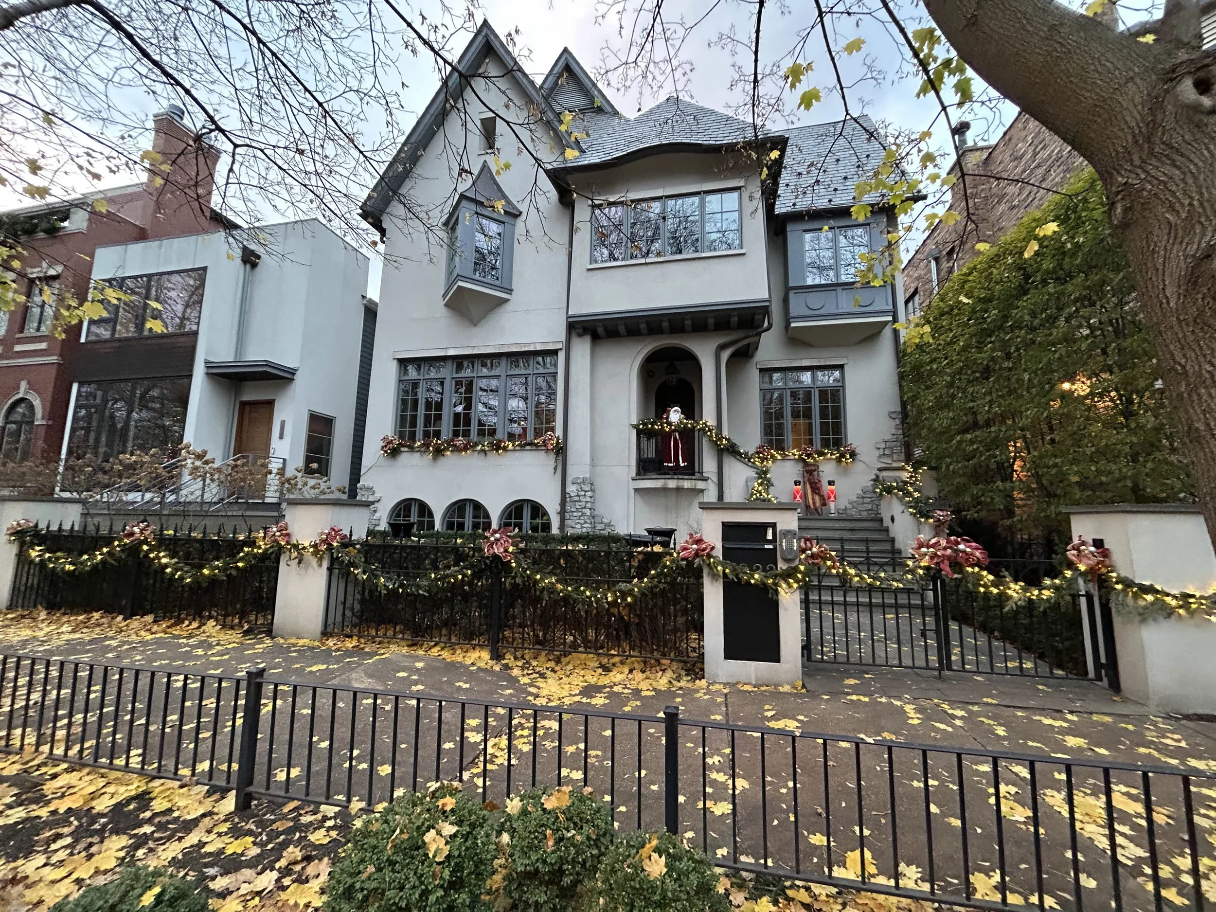 Residential holiday lighting installation by Reflect Window Cleaning (RWC) featuring professionally installed Christmas lights and seasonal decorations like garland wreaths ect on a large home.