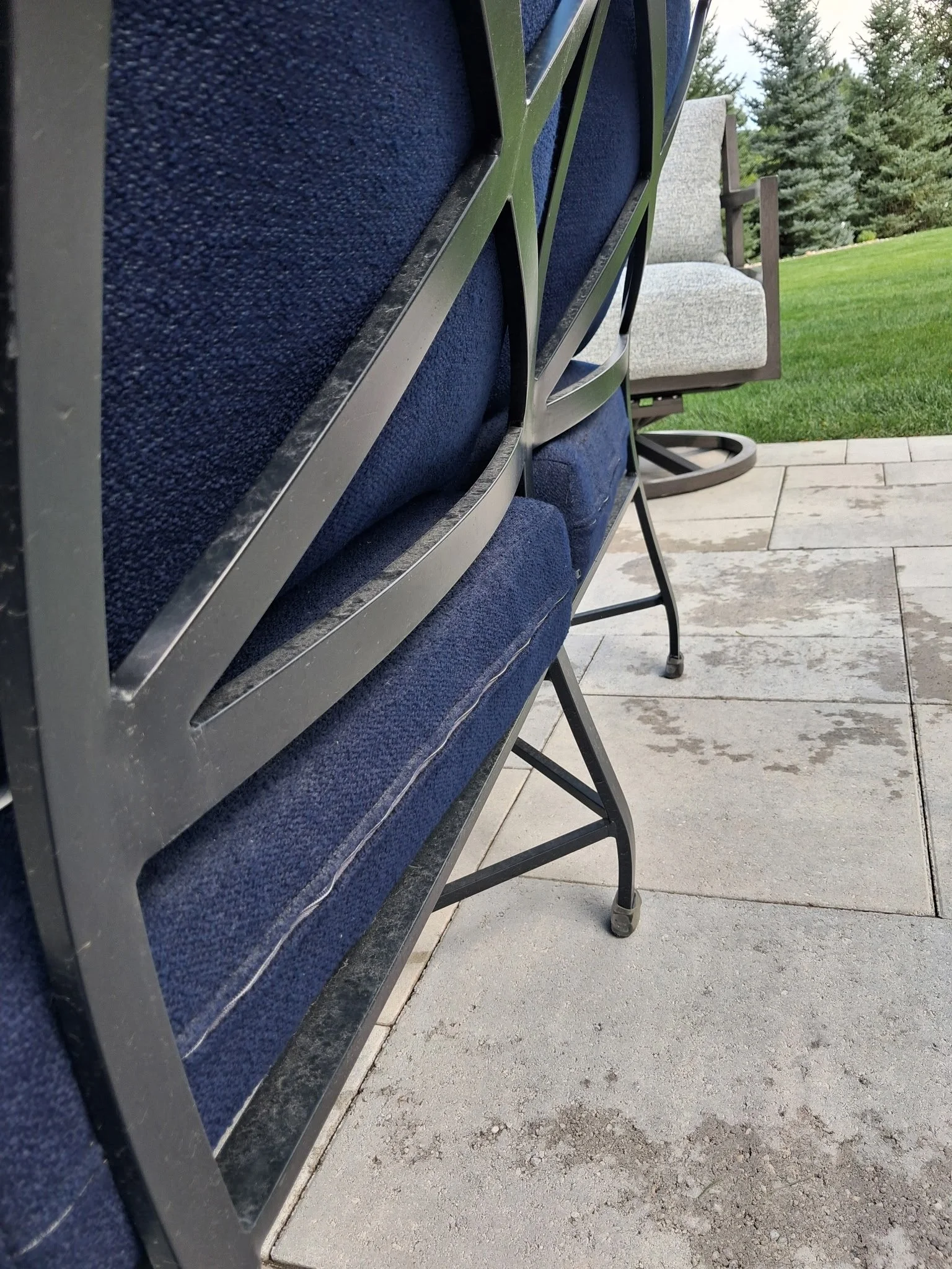 Outdoor patio furniture and living area before detailed by Reflect Window Cleaning (RWC) as part of residential exterior property care.