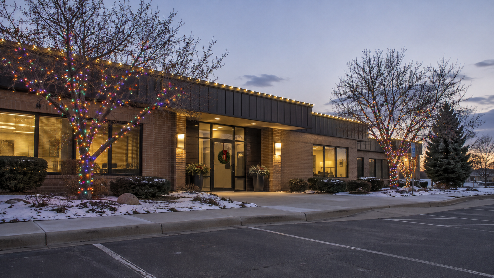 Commercial holiday lighting by Reflect Window Cleaning (RWC) featuring professional roofline Christmas lights installed on a commercial property.