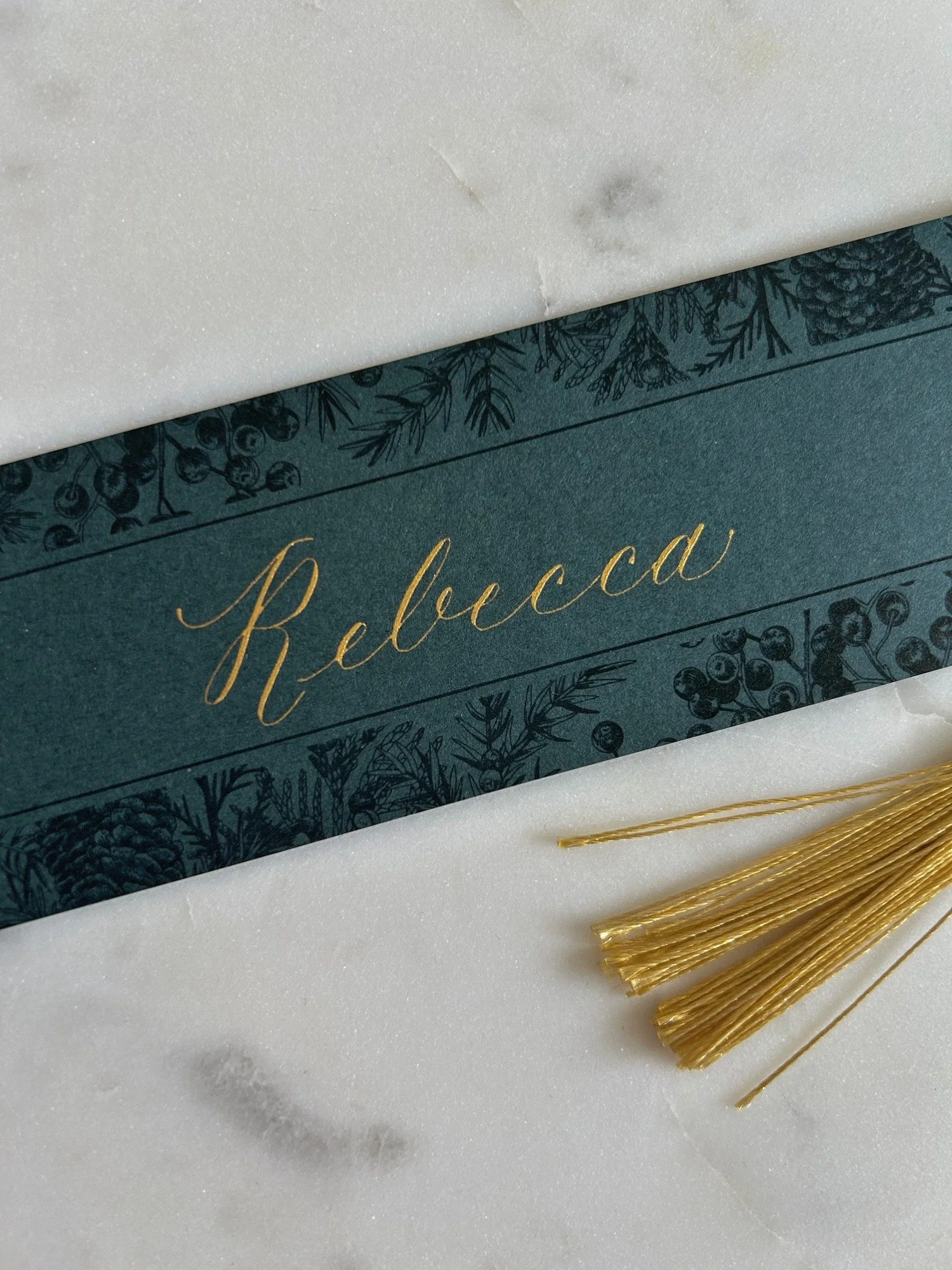 Bookmark with modern script calligraphy in gold ink