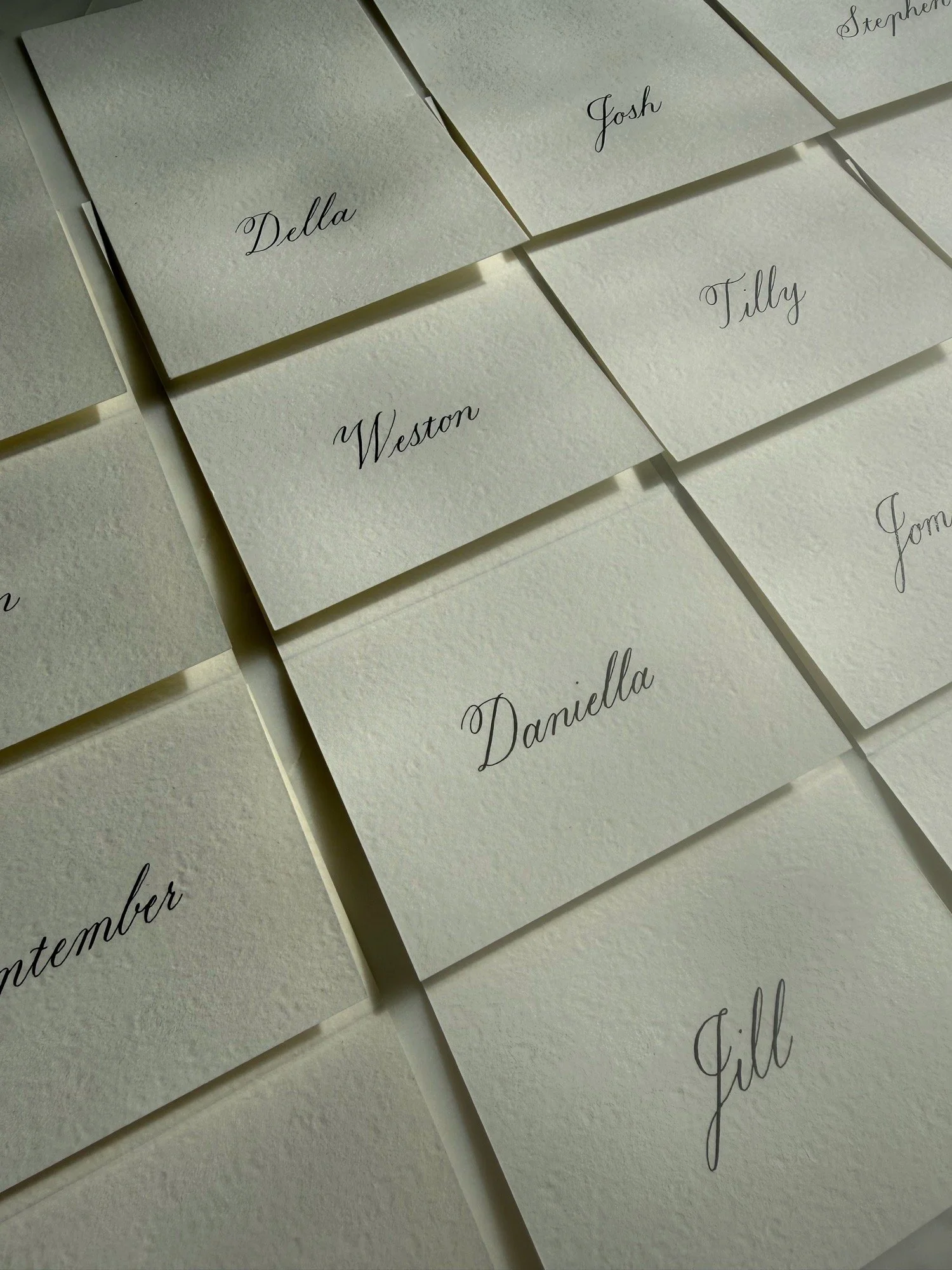 Tented wedding and dinner place cards with blank ink calligraphy