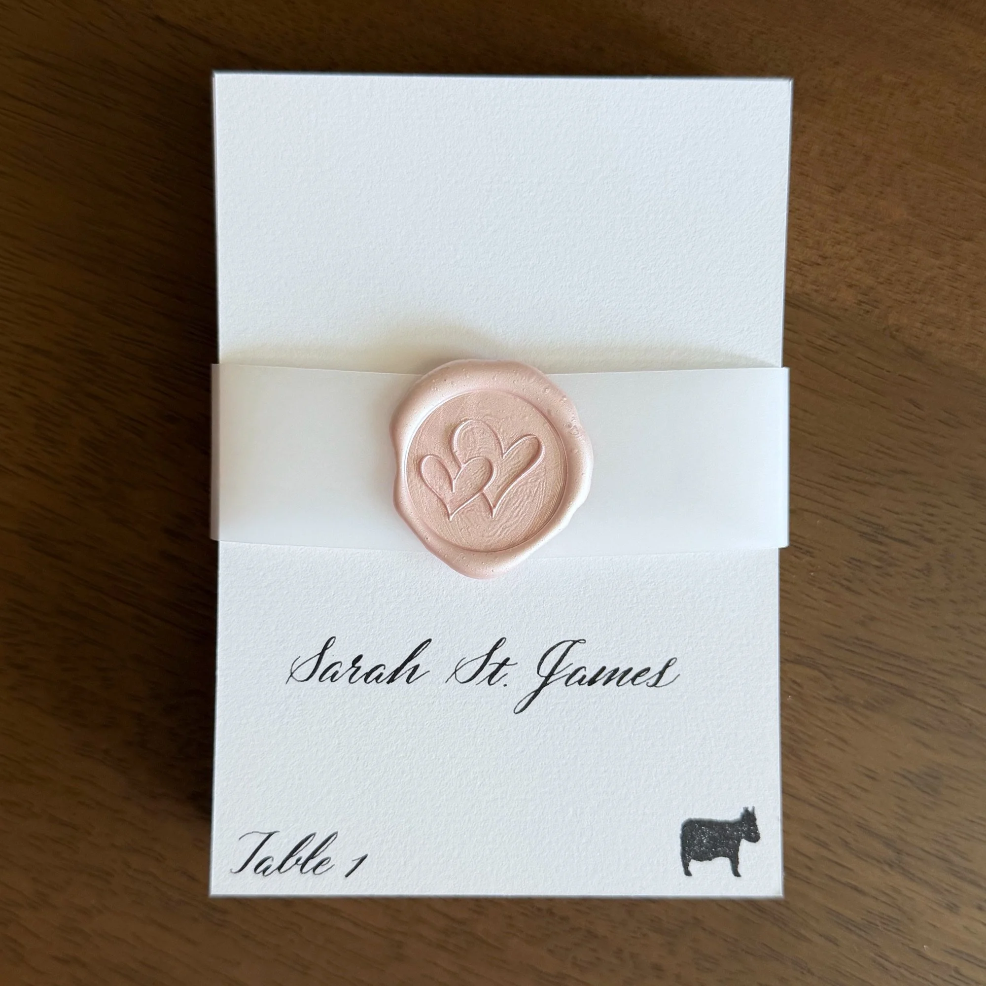 Wedding escort cards with pink wax seal