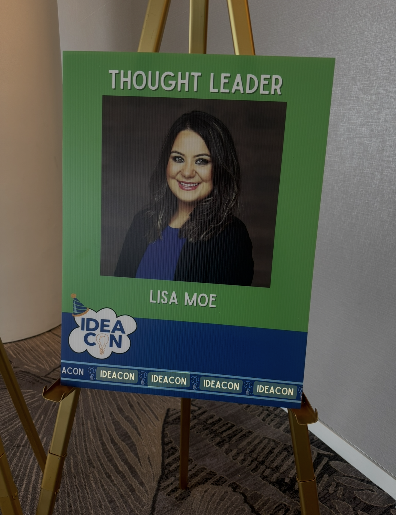 IDEAcon event sign on an easel featuring Lisa Moe's headshot under the title Thought Leader