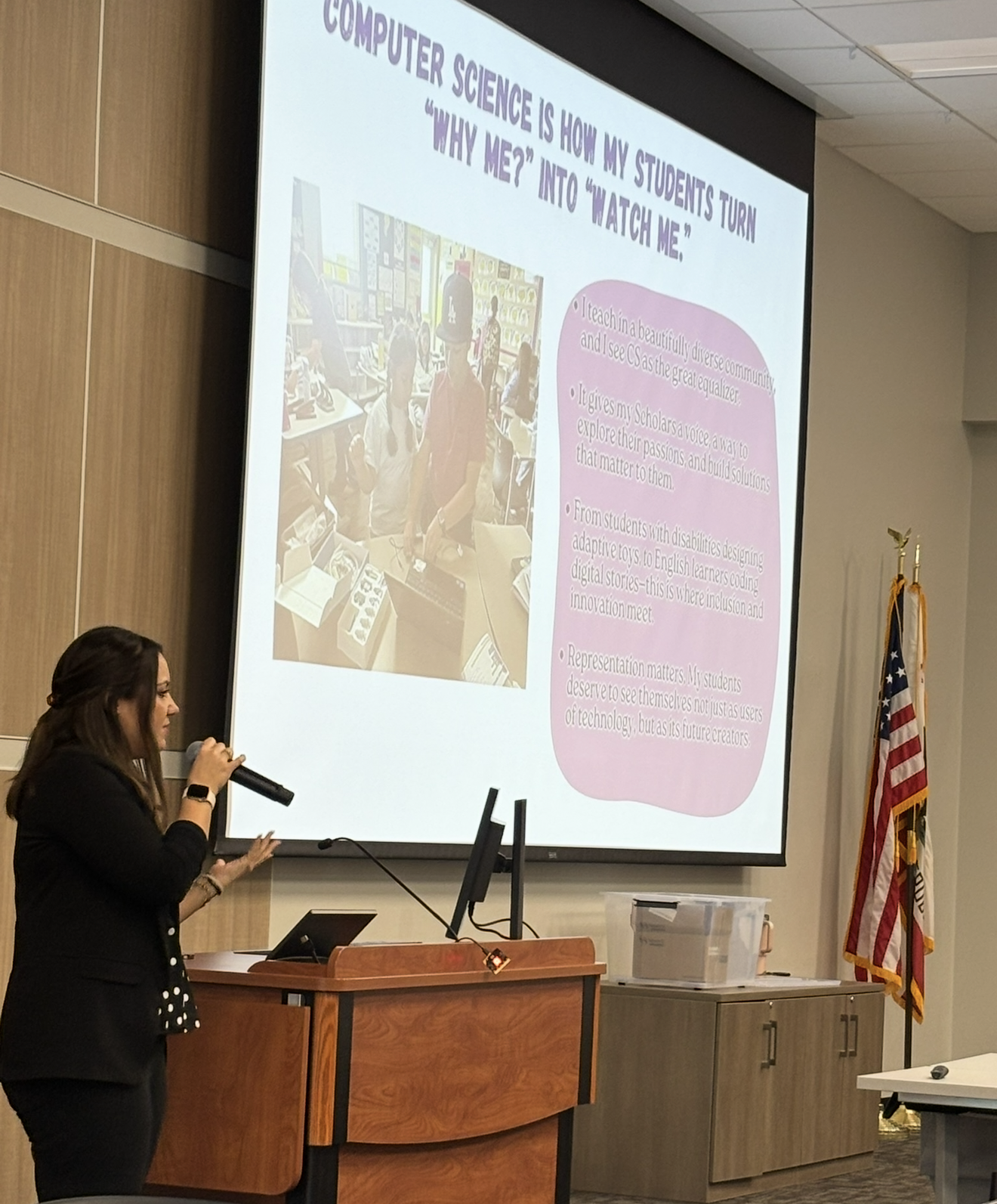Lisa Moe presenting a slide that reads "Computer science is how my students turn 'Why me?' into 'Watch me.'"
