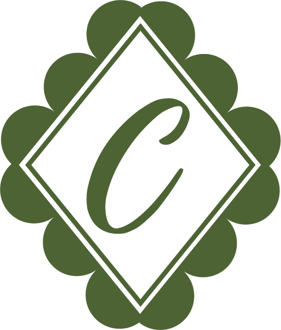 A green decorative logo with a large, stylized letter 'C' in the center, surrounded by a scalloped border.