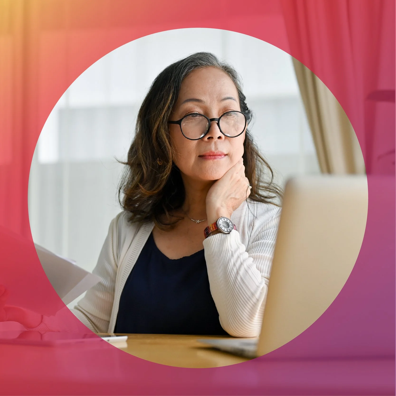 Woman looking at a laptop in an office setting