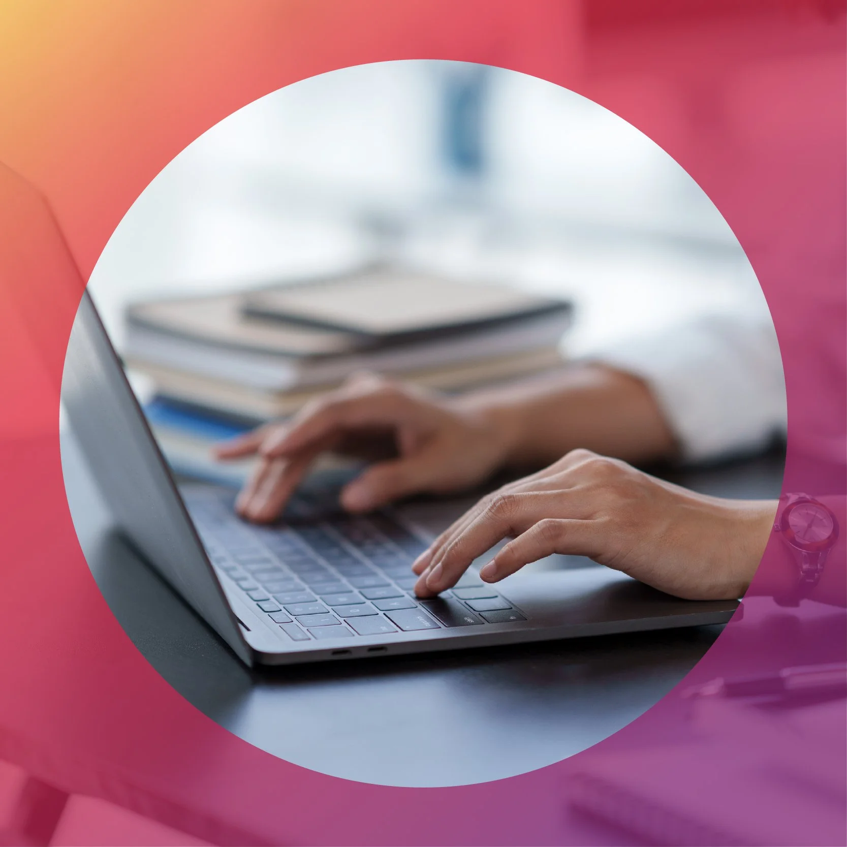 Pair of hands using a laptop in an office setting