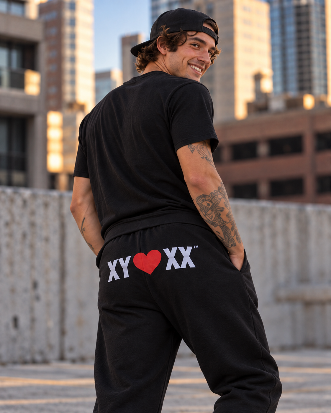Male model wearing black Sweatpants with the large XY heart XX rear logo