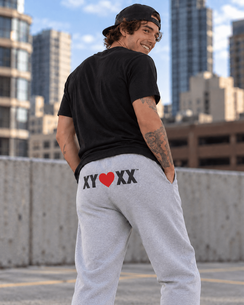 Male model wearing gray Sweatpants with the large XY heart XX rear logo