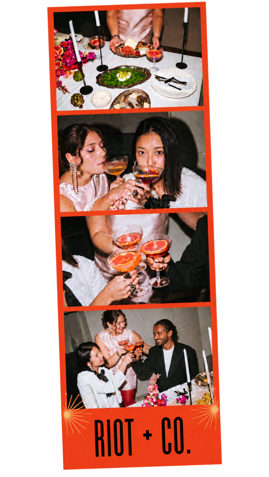 A photo booth strip featuring four images from a celebration. The top image shows a table set with colorful plates, candles, and decorations. The second and third images depict a diverse group of friends toasting with pink-colored drinks. The last image shows the group smiling and raising their glasses in a toast. The bottom of the strip has the text "RIOT + CO." with decorative fireworks.