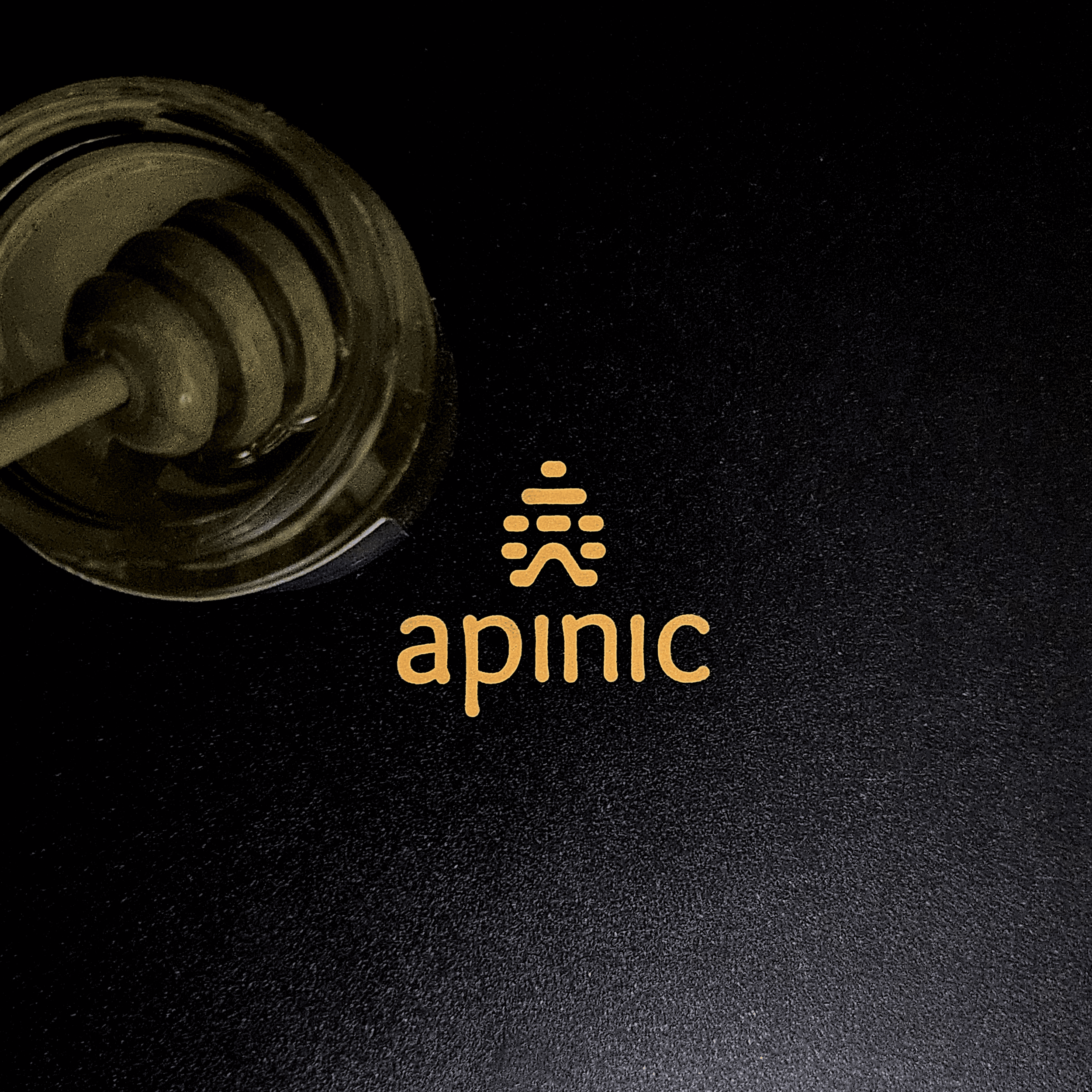 Close-up of a black electronic device with a coiled metal element, gold-colored text, and symbols on the surface.