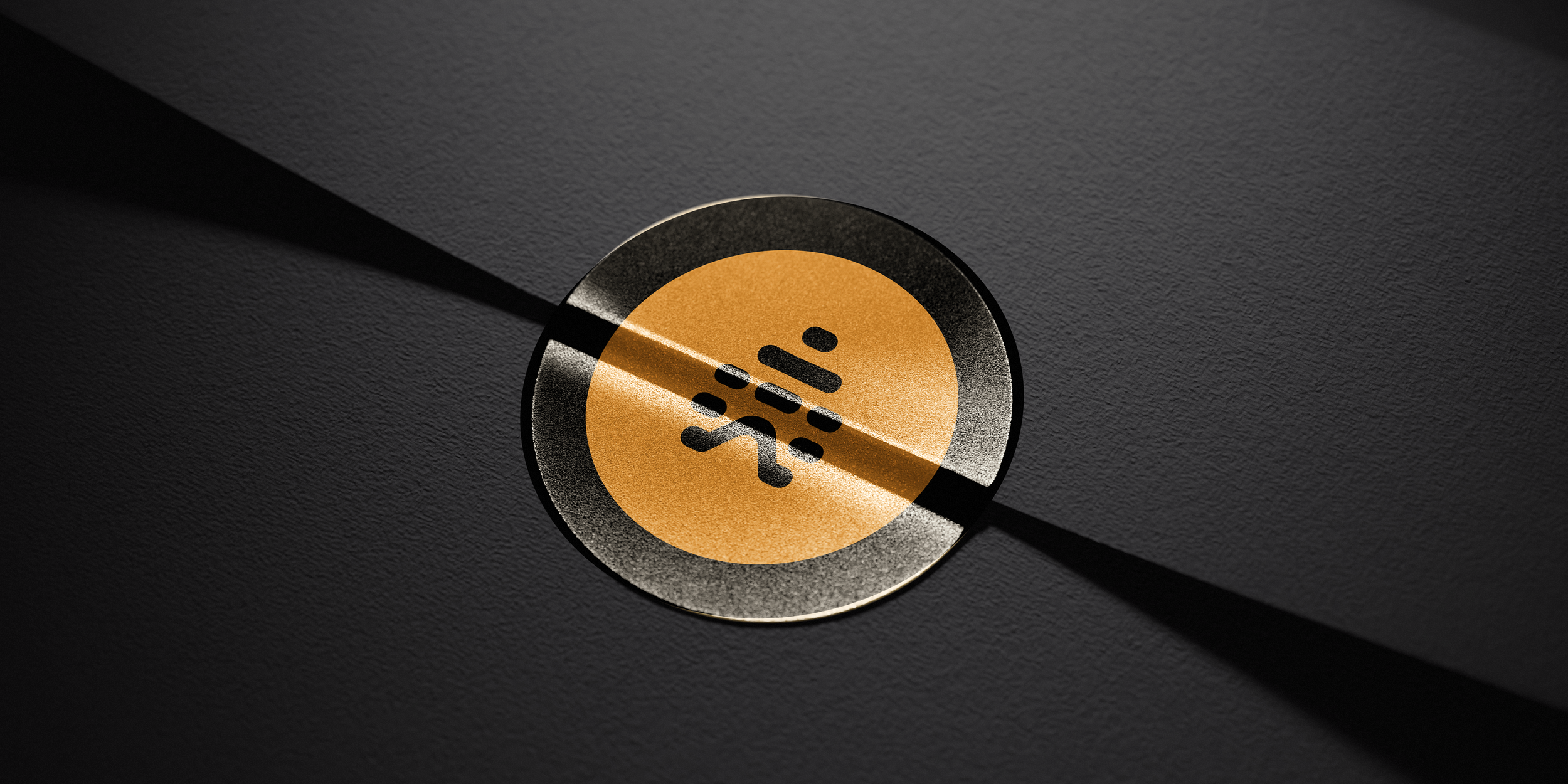 Close-up of a gold-colored circular button with a Wi-Fi signal icon, partially covered by a diagonal black stripe, on a dark textured surface.