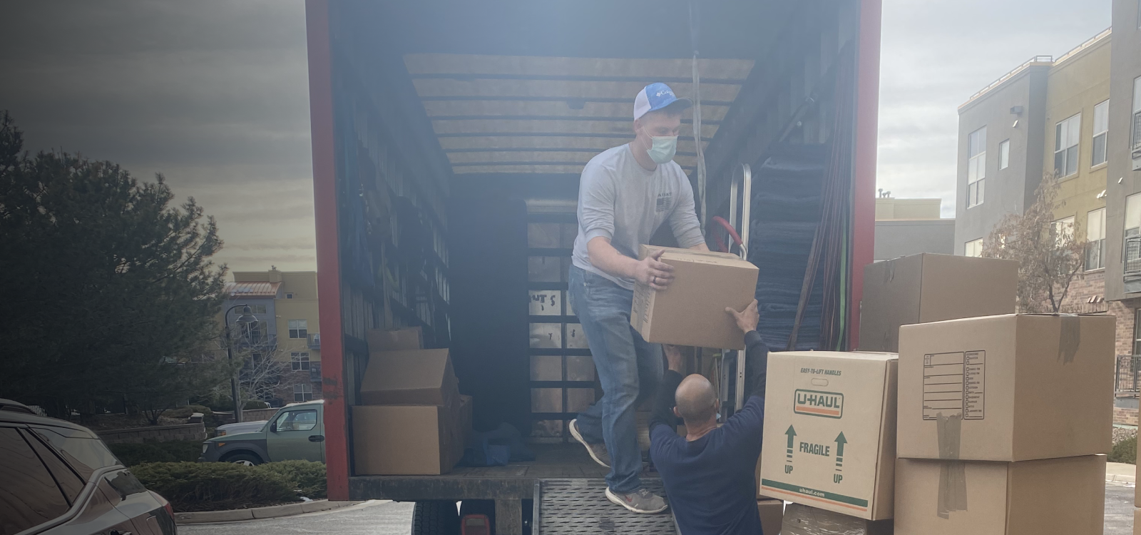 Specialty movers loading furniture and boxes into a moving van