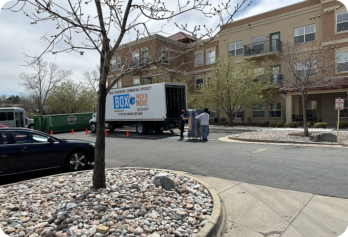 Denver moving company truck outside an apartment building