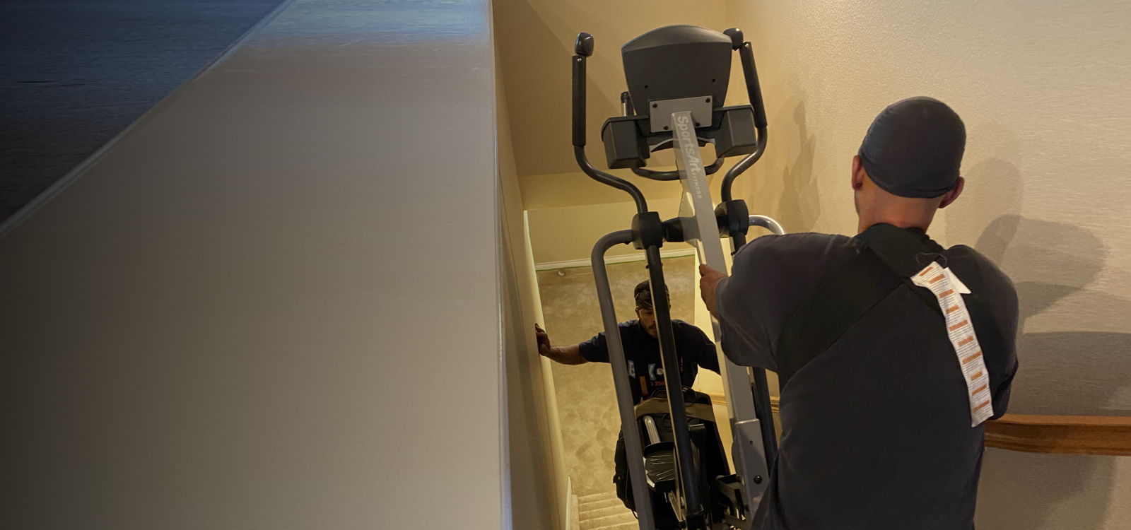 Fitness equipment movers handling an elliptical machine in Colorado Springs