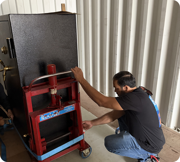 Monument movers securing a gun safe on a dolly