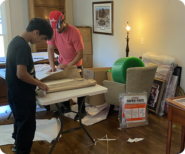 Household items packing services, mover wrapping items in protective paper