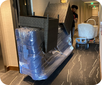 Furniture movers transporting protected furniture