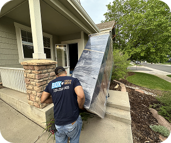 Furniture delivery mover carrying a wrapped item