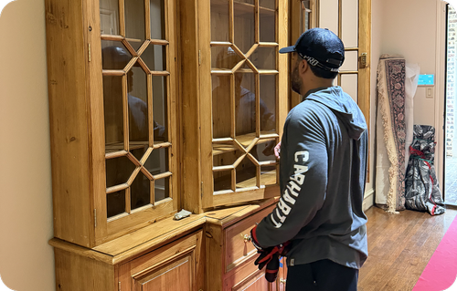 Home decluttering specialist handling wooden furniture