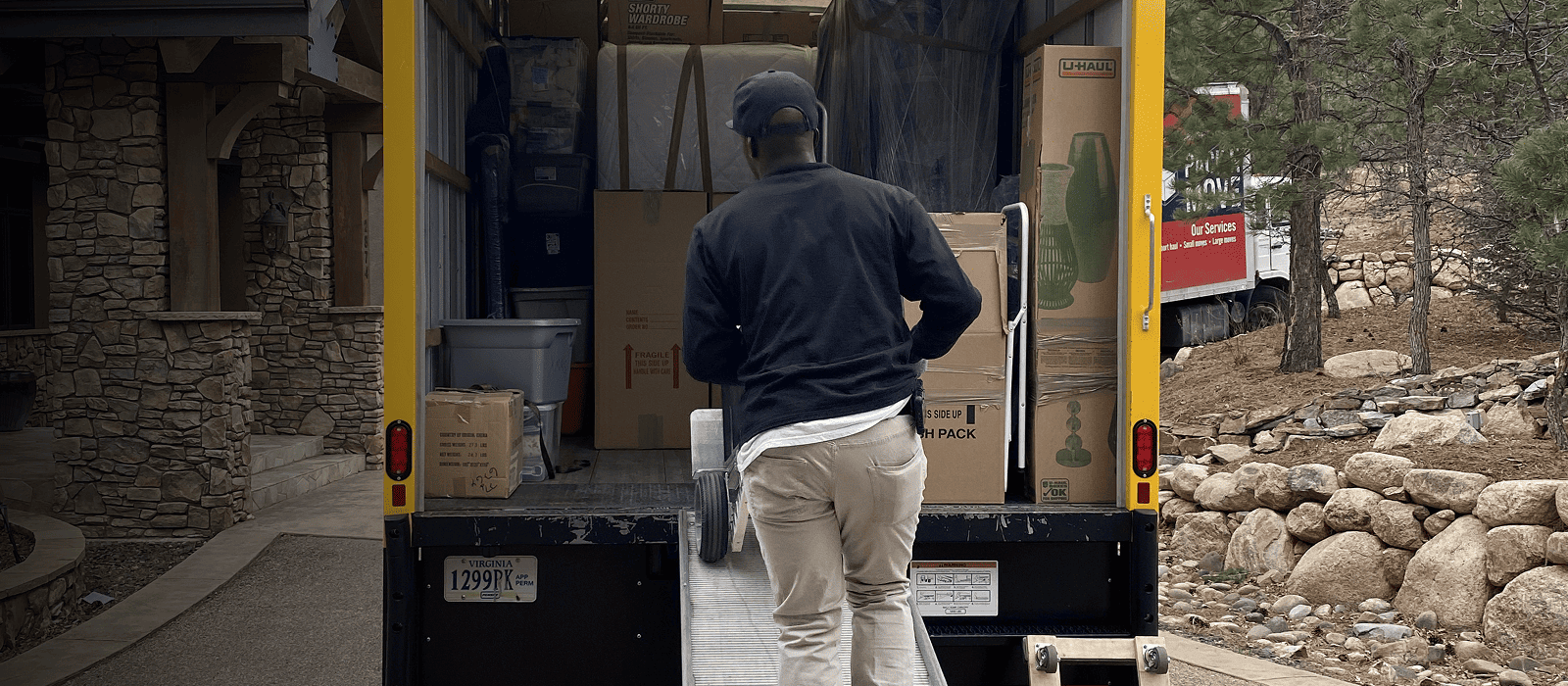 Arvada movers loading household boxes into a moving truck