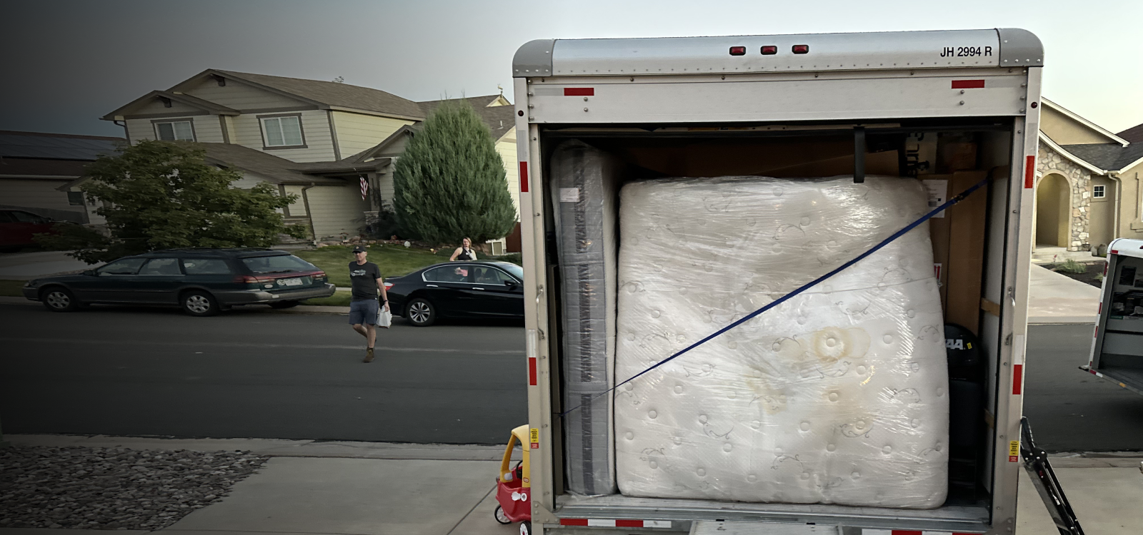 Moving truck with wrapped mattress in Highlands Ranch, CO