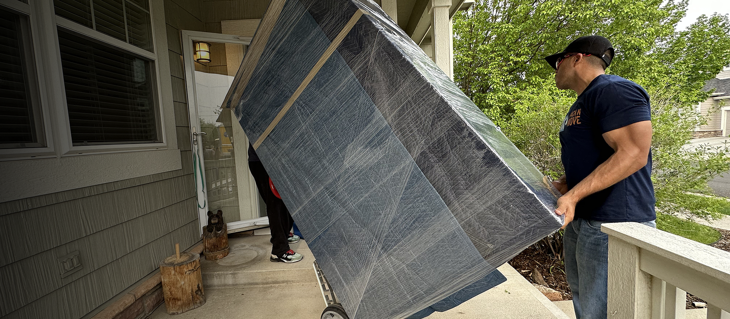 Furniture and appliance movers loading a truck