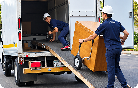 Furniture movers using a dolly and loading ramp