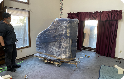 White-glove movers handling wrapped furniture